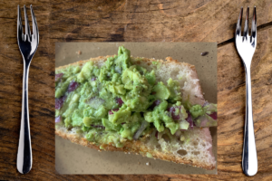 spreading guacamole onto bread